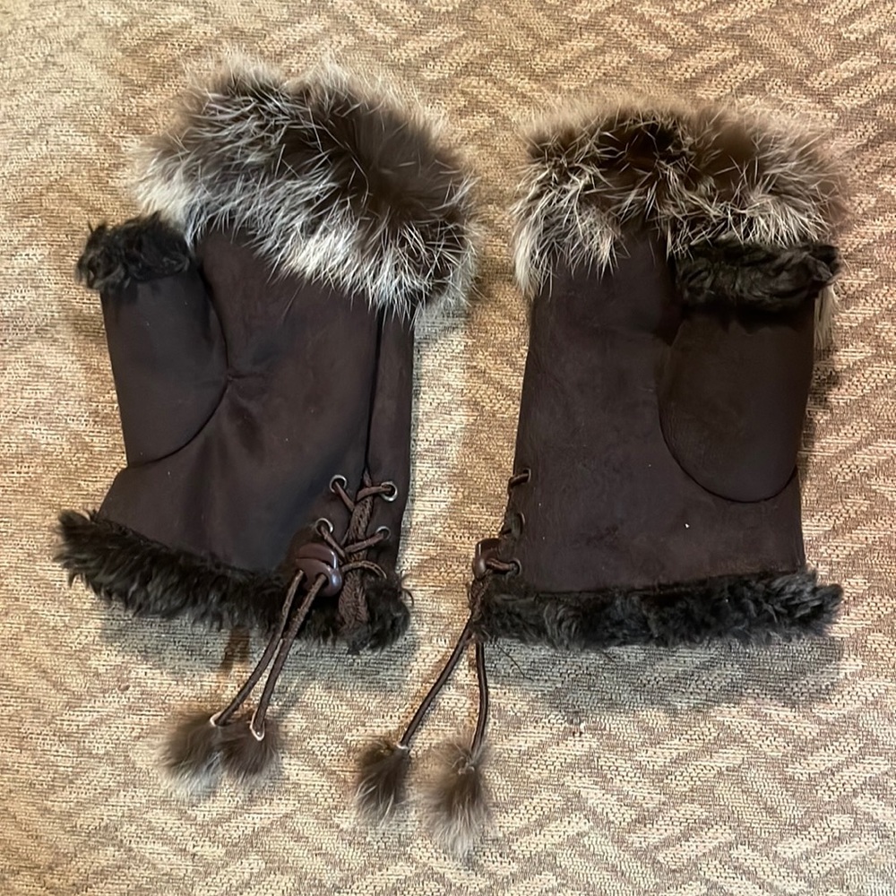 Brown mittens adjustable for size that are super soft.